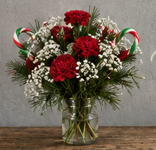 AI staging concept: red and white bouquet in a glass vase, photographed from the front